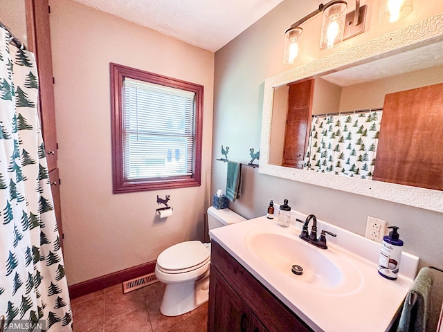 bathroom featuring tile patterned floors, vanity, and toilet