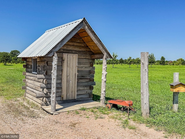 view of outbuilding with a yard