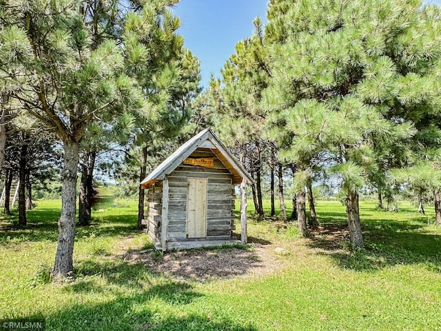 view of outbuilding with a lawn