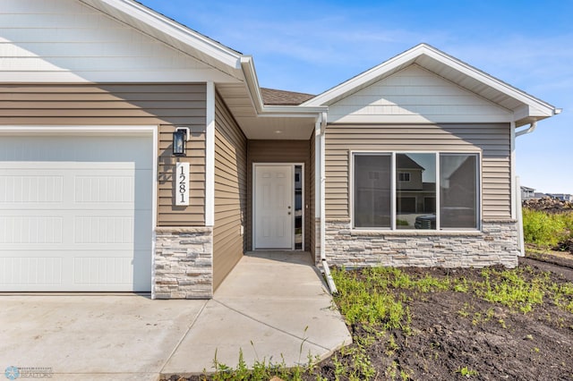 view of front facade featuring stone siding and an attached garage