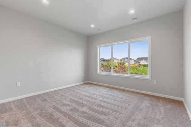 spare room with recessed lighting, carpet flooring, and baseboards