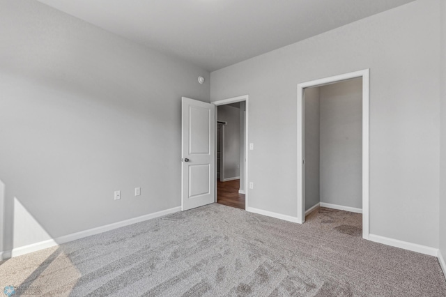 unfurnished bedroom featuring carpet and baseboards