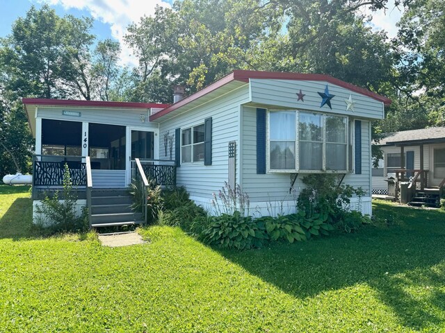 2769 28th St NW Unit 140, Wheeler Twp, MN 56623 - view of front of house featuring a front yard