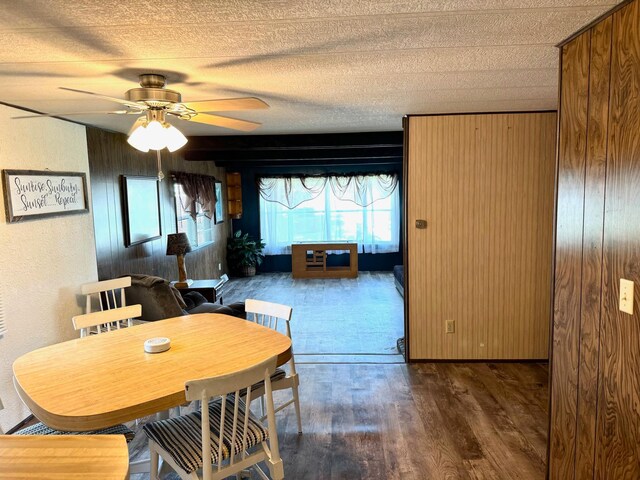 2769 28th St NW Unit 140, Wheeler Twp, MN 56623 - dining space featuring a ceiling fan, wood walls, a textured ceiling, and wood finished floors