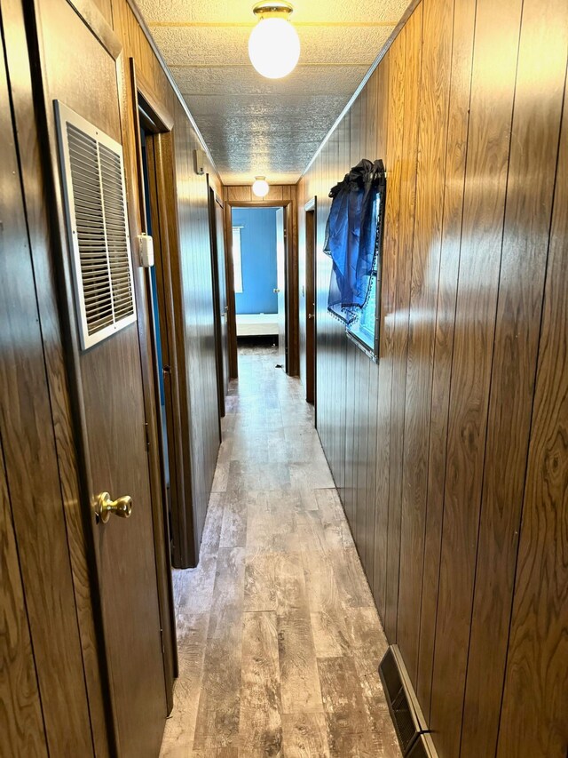2769 28th St NW Unit 140, Wheeler Twp, MN 56623 - hallway featuring wooden walls and visible vents
