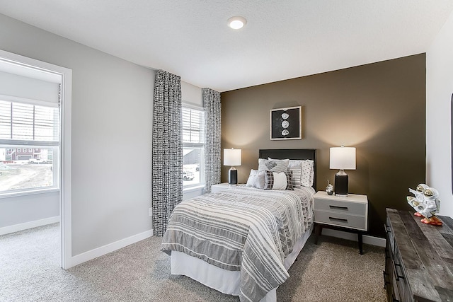 carpeted bedroom featuring multiple windows