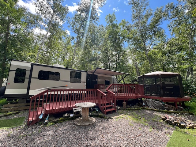 rear view of house featuring a deck