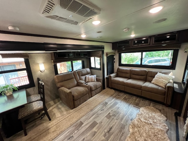 living room with visible vents and wood finished floors