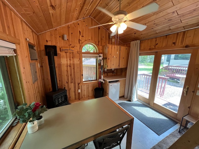 kitchen featuring light countertops, wood walls, lofted ceiling, wood ceiling, and dishwasher