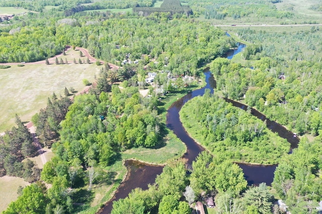 aerial view with a water view and a forest view