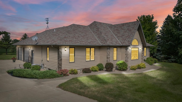 view of front of home featuring a garage and a yard