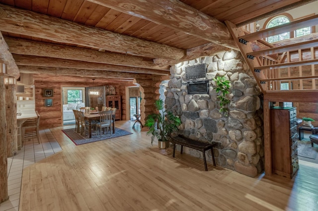 unfurnished living room with log walls and light wood-type flooring