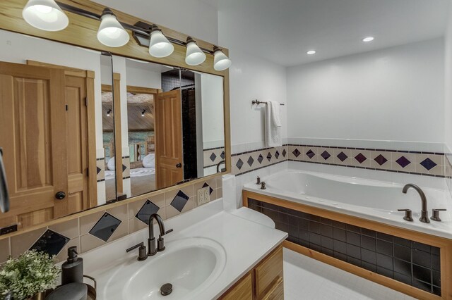 bathroom with tiled bath and vanity