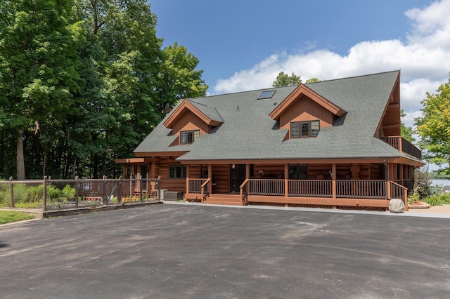 log home featuring a porch