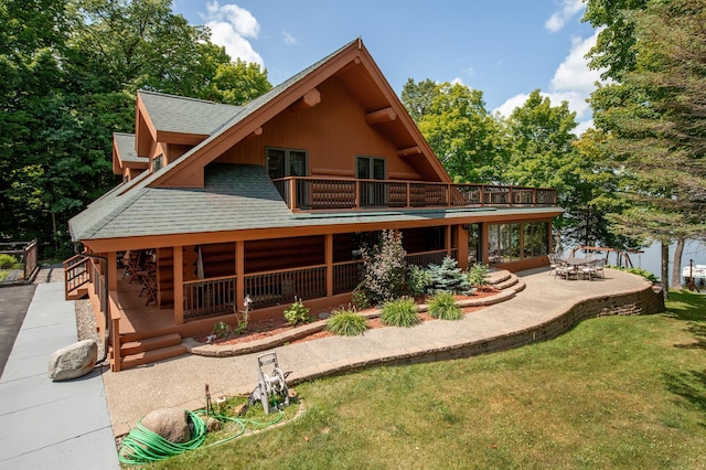 back of property featuring a patio area and a yard