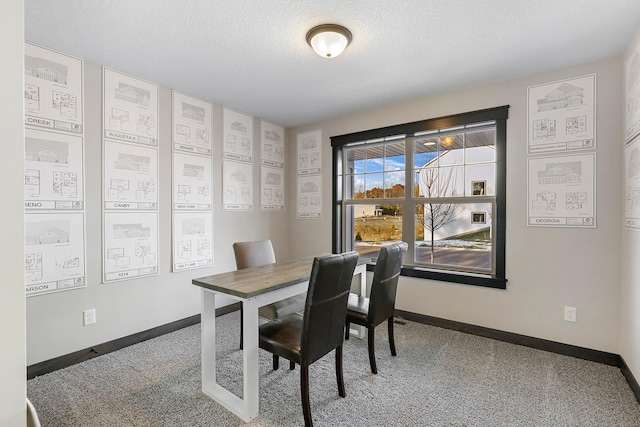 dining space with a textured ceiling and carpet