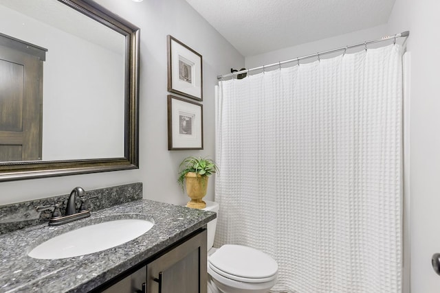 bathroom with curtained shower, toilet, a textured ceiling, and vanity