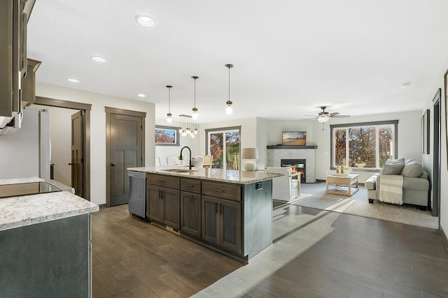 kitchen featuring a center island with sink, dark wood-type flooring, a wealth of natural light, and sink