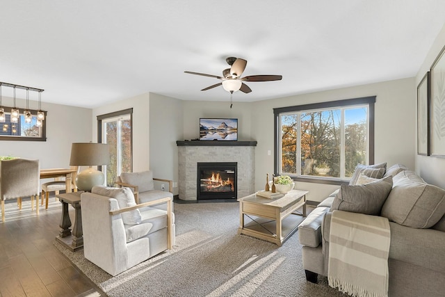 living room featuring wood-type flooring, a wealth of natural light, and ceiling fan