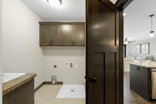 washroom with hookup for a washing machine, a textured ceiling, ceiling fan, hookup for an electric dryer, and light hardwood / wood-style floors