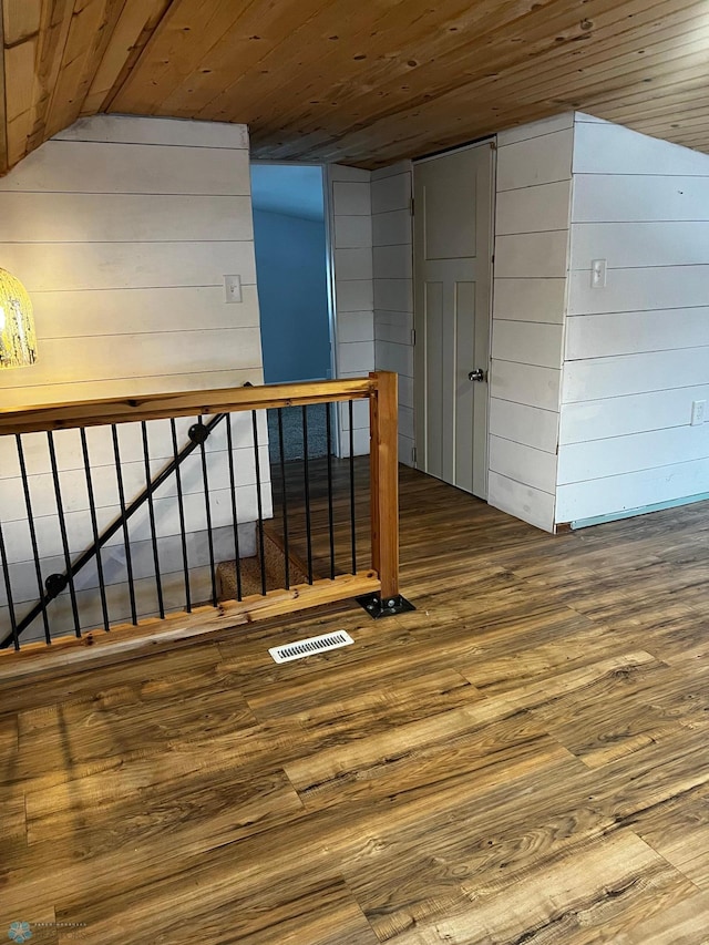 bonus room featuring hardwood / wood-style floors, wood walls, and wood ceiling