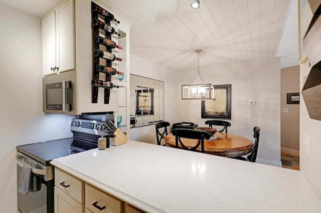 kitchen with wood ceiling, pendant lighting, appliances with stainless steel finishes, and a chandelier