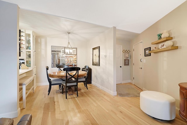 dining room featuring an inviting chandelier and light hardwood / wood-style floors