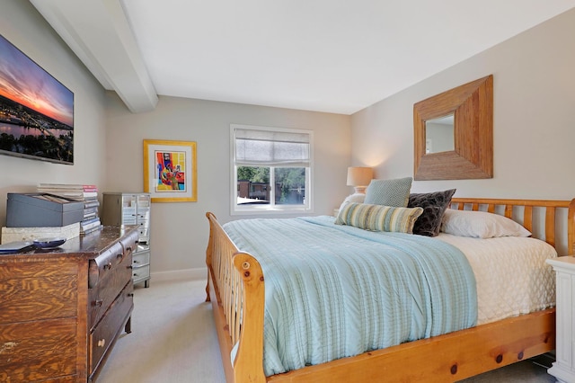 bedroom featuring light carpet and beam ceiling