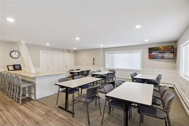 dining area featuring light hardwood / wood-style flooring and a baseboard radiator