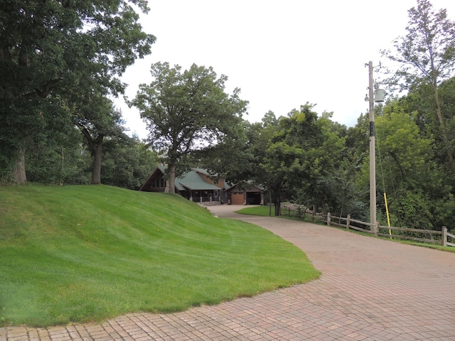 20578 317th St, Farming Twp, MN 56310 - view of property's community with a garage, decorative driveway, fence, and a lawn