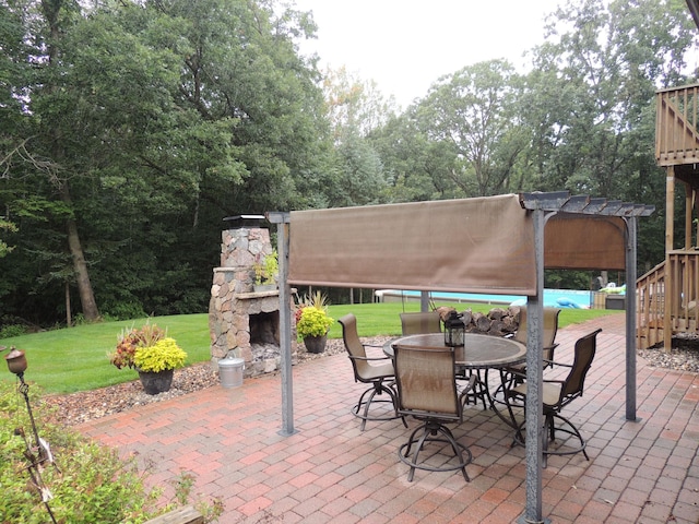 view of patio / terrace with an outdoor stone fireplace