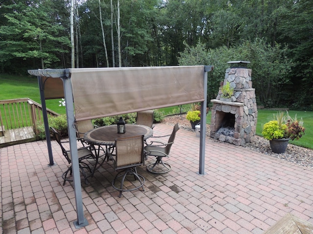 view of patio with an outdoor stone fireplace