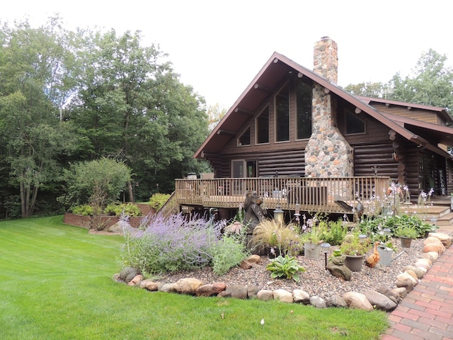 20578 317th St, Farming Twp, MN 56310 - rear view of property featuring a yard, a chimney, a wooden deck, and log siding