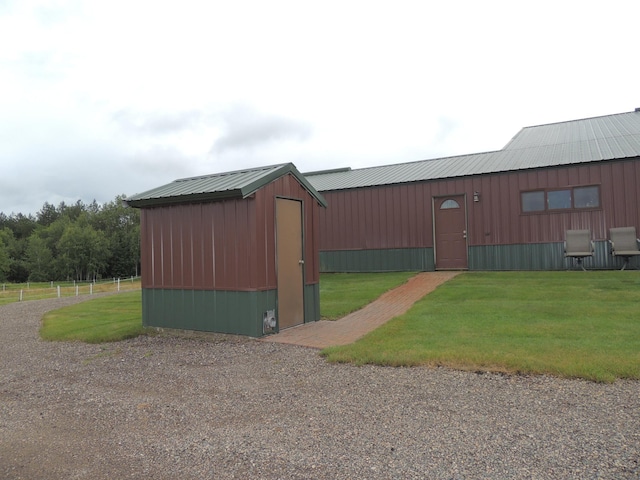 view of outbuilding with a yard