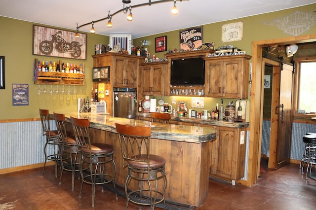 20578 317th St, Farming Twp, MN 56310 - bar with finished concrete floors, stainless steel refrigerator, rail lighting, and bar area