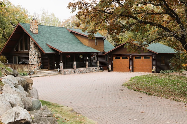 20578 317th St, Farming Twp, MN 56310 - log cabin with decorative driveway, log siding, a chimney, and a porch