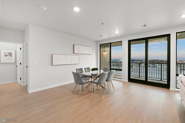 dining space with light hardwood / wood-style flooring