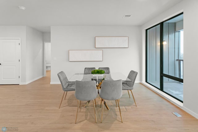 dining space featuring light wood-type flooring