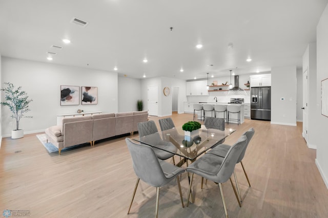 dining area featuring light wood-type flooring