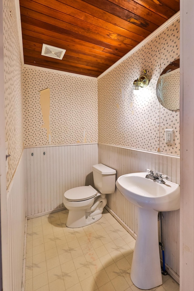 bathroom with crown molding, toilet, and wooden ceiling