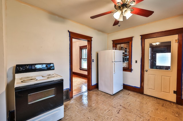 kitchen with light parquet flooring, white appliances, and ceiling fan