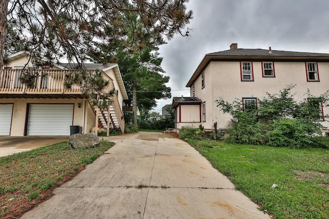 view of property exterior with a lawn and a garage