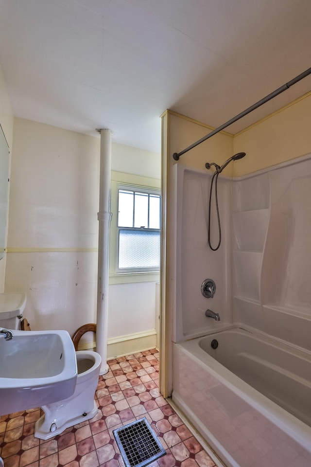 bathroom with toilet and tub / shower combination