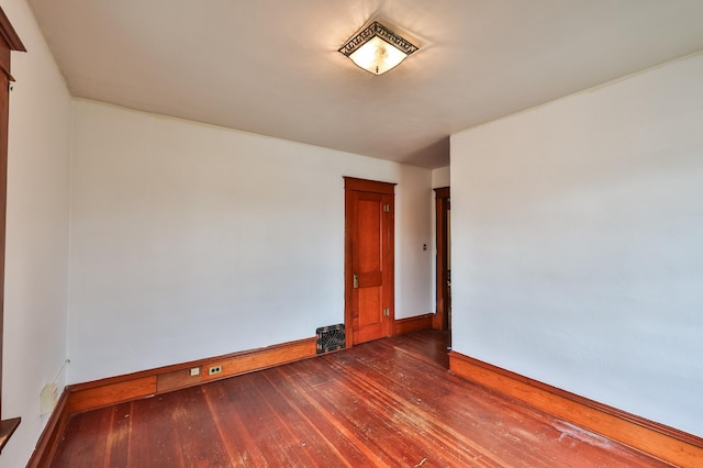 empty room featuring dark hardwood / wood-style flooring