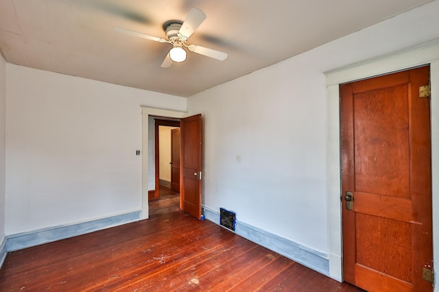 spare room featuring ceiling fan and dark hardwood / wood-style flooring