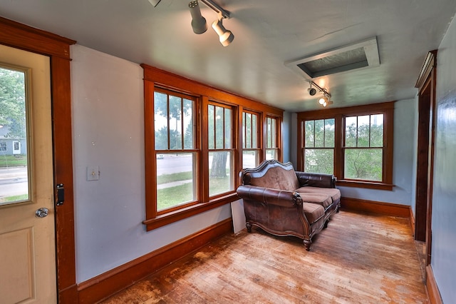 sitting room featuring hardwood / wood-style floors and track lighting