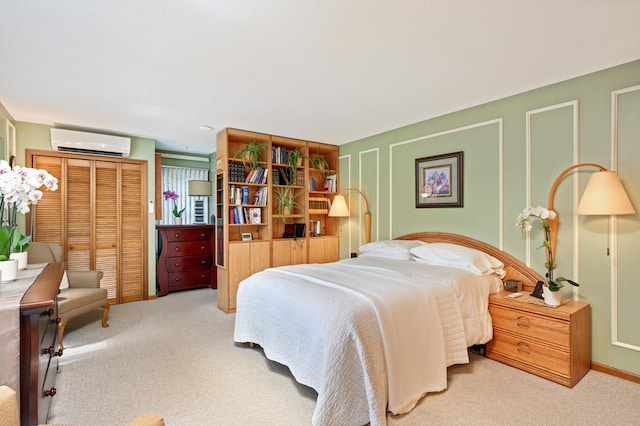 bedroom featuring a wall mounted AC and light carpet