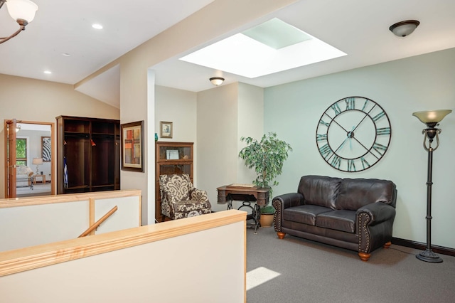 interior space featuring lofted ceiling with skylight and carpet floors