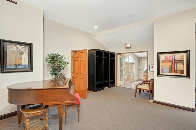 carpeted dining room featuring vaulted ceiling