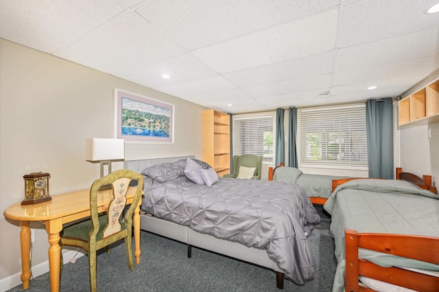 carpeted bedroom featuring a paneled ceiling